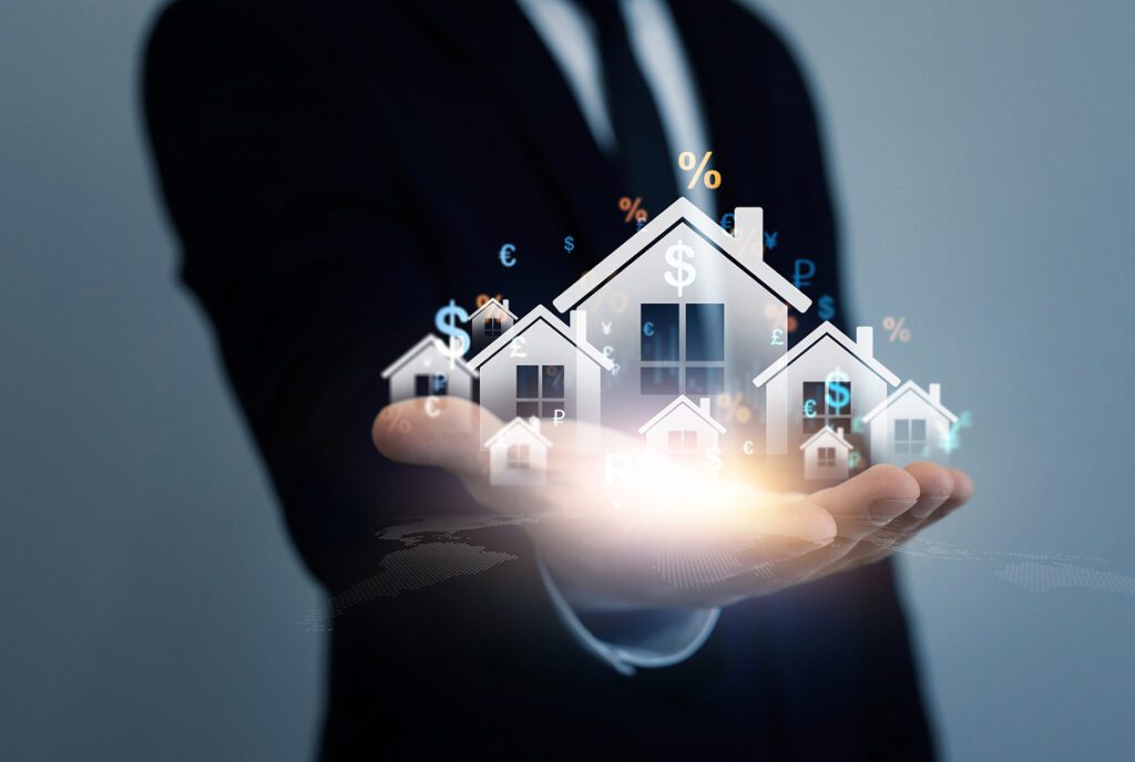Businessman holding digital houses